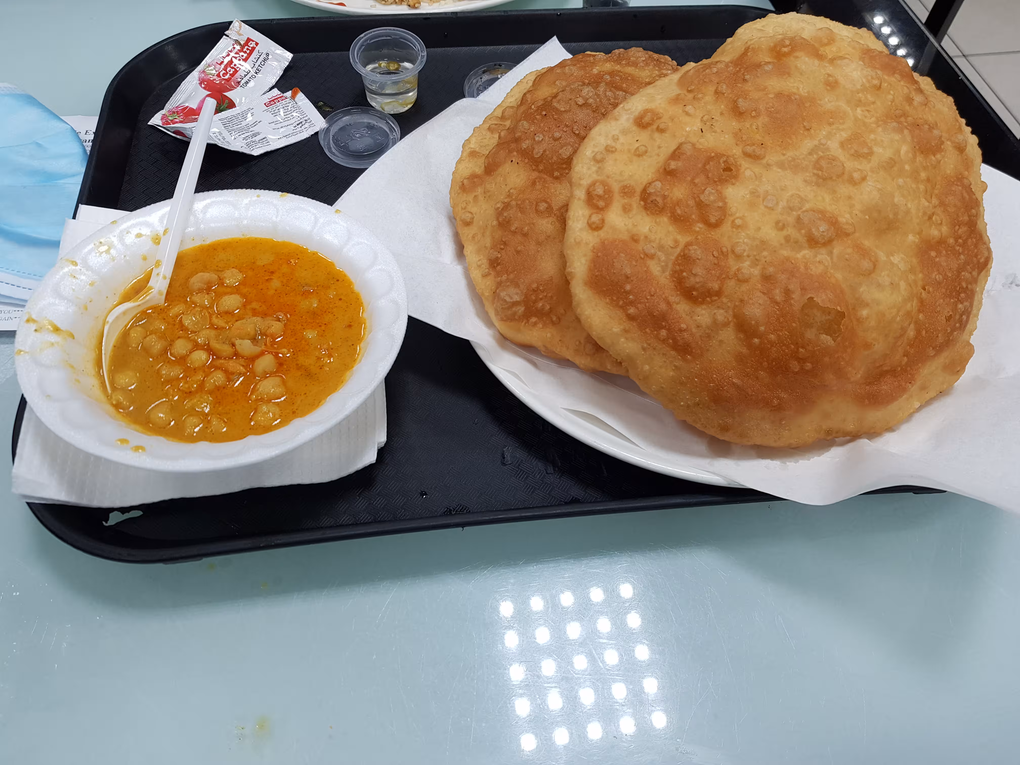 Two bhatures with a serving of chickpeas