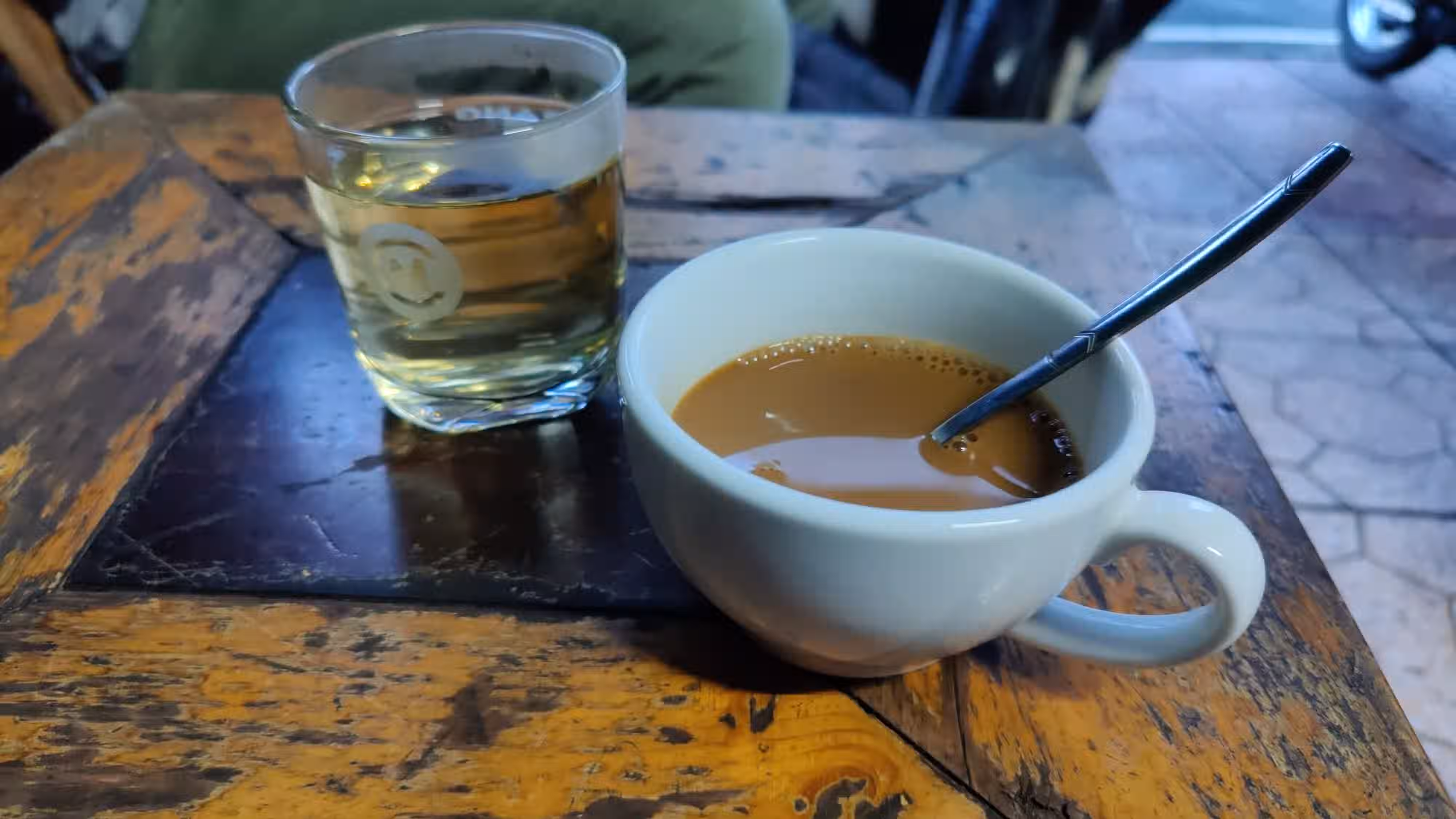 A cup of coffee and a cup of green tea.